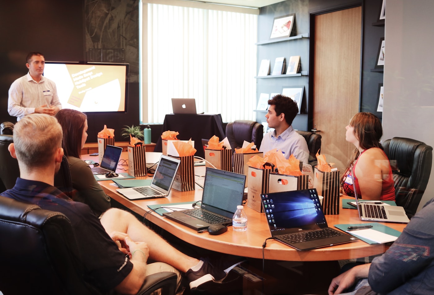 Advisers and a client around the Marsden Holt boardroom table reviewing a forecast